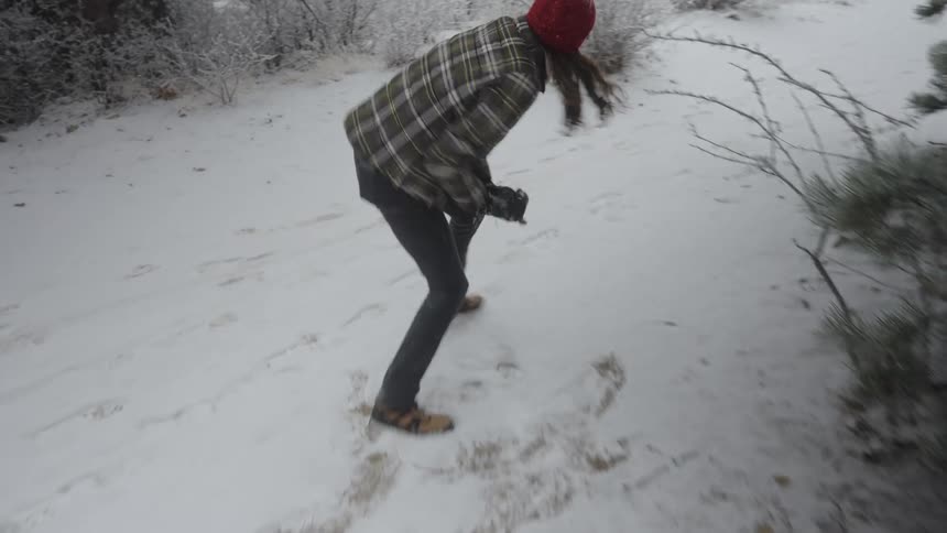 A man and woman having a snowball fight