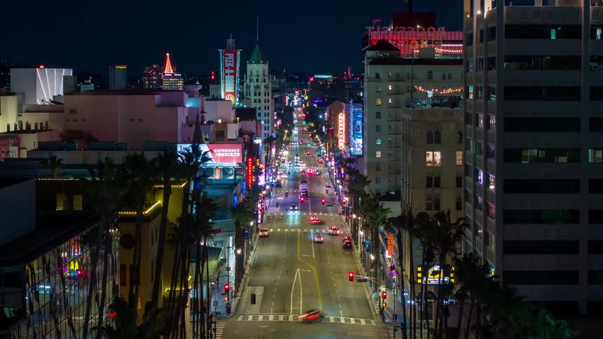 Lights glow on Los Angeles buildings as traffic moves on Hollywood Boulevard at night