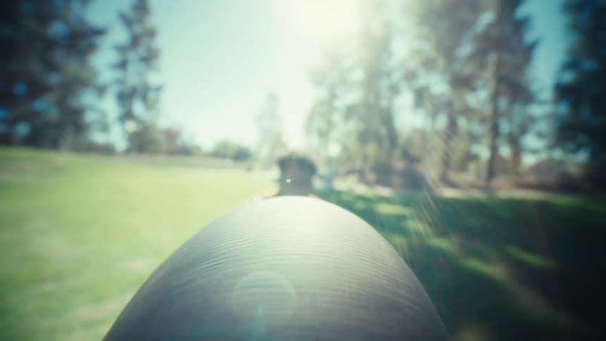 Young adult black man wearing football uniform catching a football flying on his direction outdoors during day time
