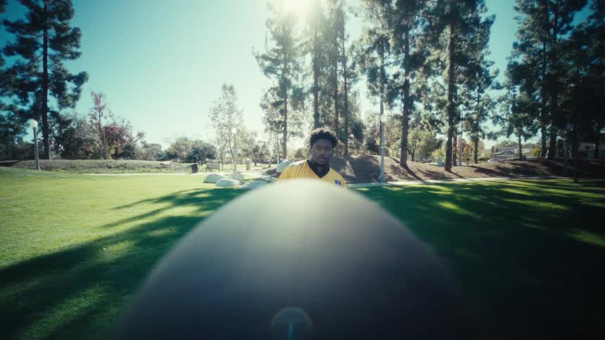 The man catches the football in the park