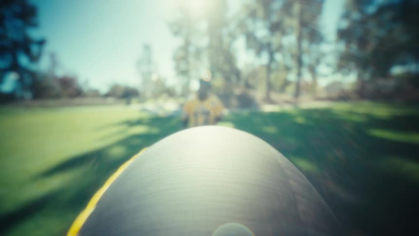 Young adult black man wearing american football uniform catches a football that is flying on his direction at a field outdoors during day time