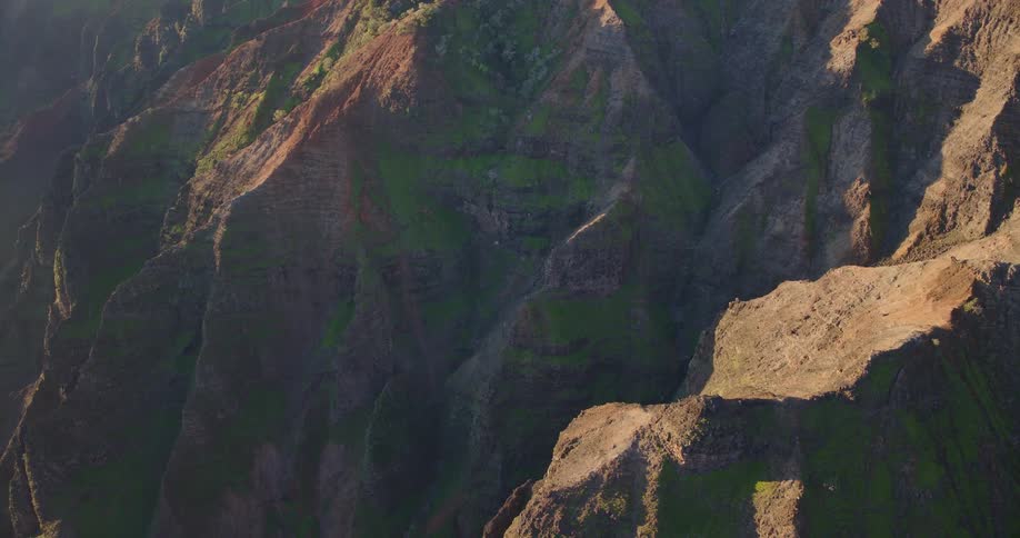 Sunlight shines on the rough terrain of mountains