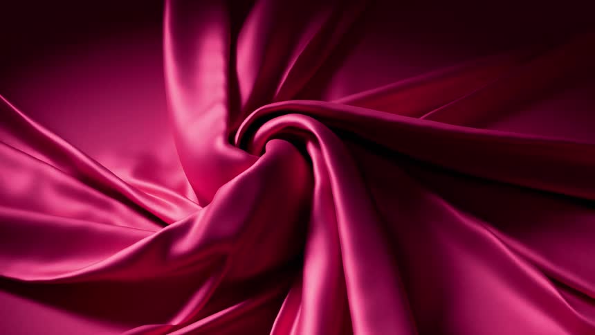 Closeup abstract shot of flowing pink fabric twisted into soft swirling folds