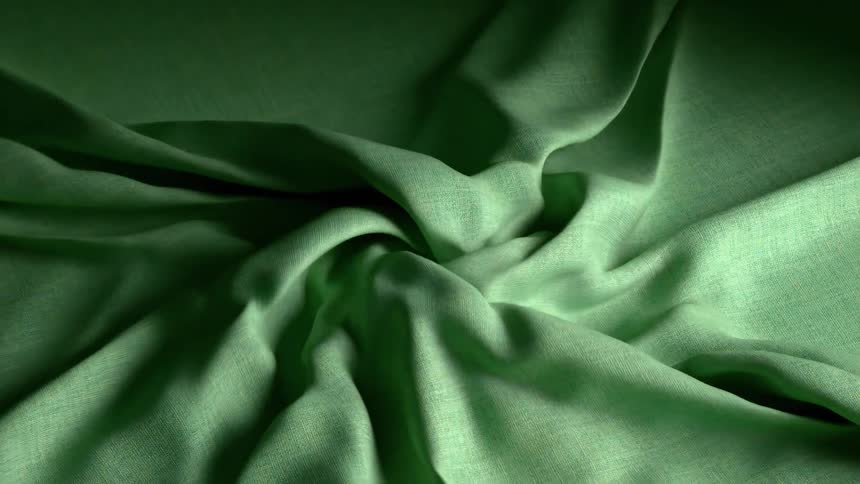 A piece of green fabric loosely wrapped inward creating a rough folded shape