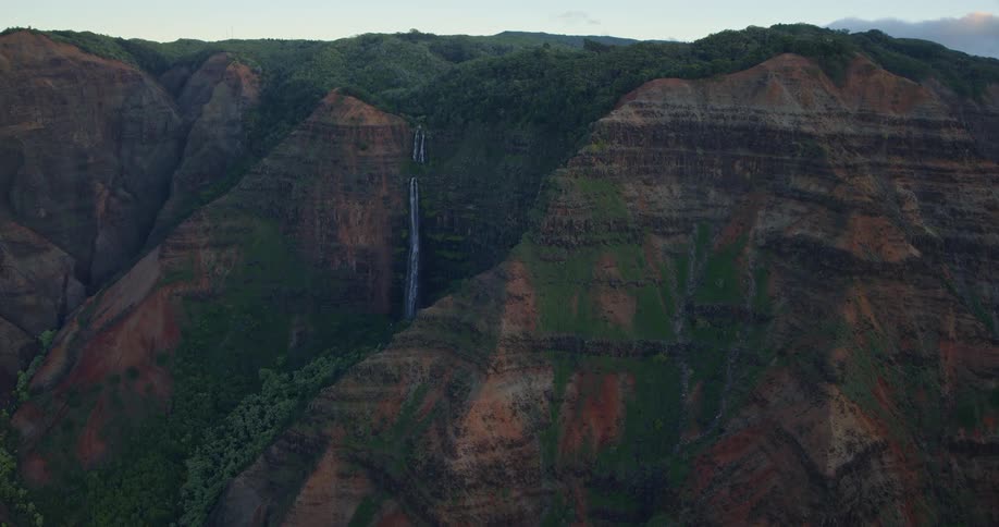 Waterfall flowing down the rough terrain of a mountainside