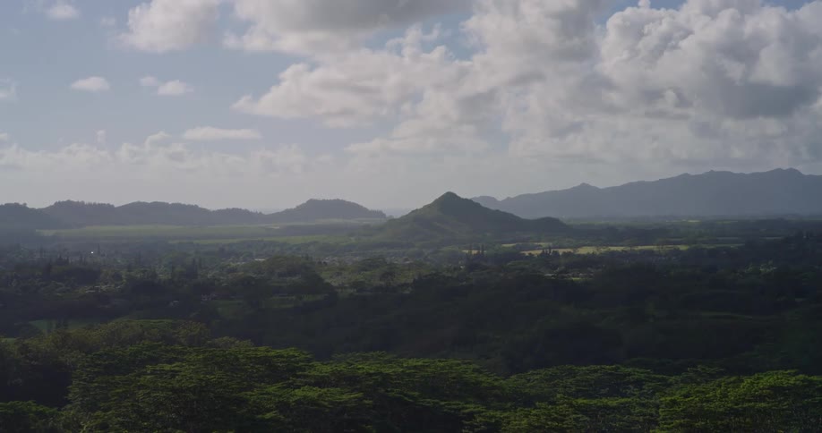The landscape is covered with trees and hills