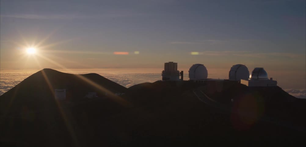 A view of some telescopes at the top of a mountain