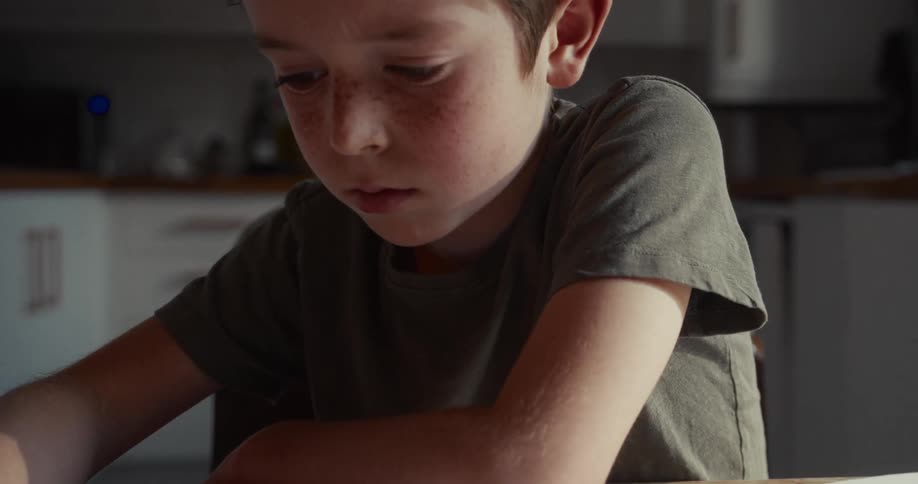 A child writing with a pen on paper