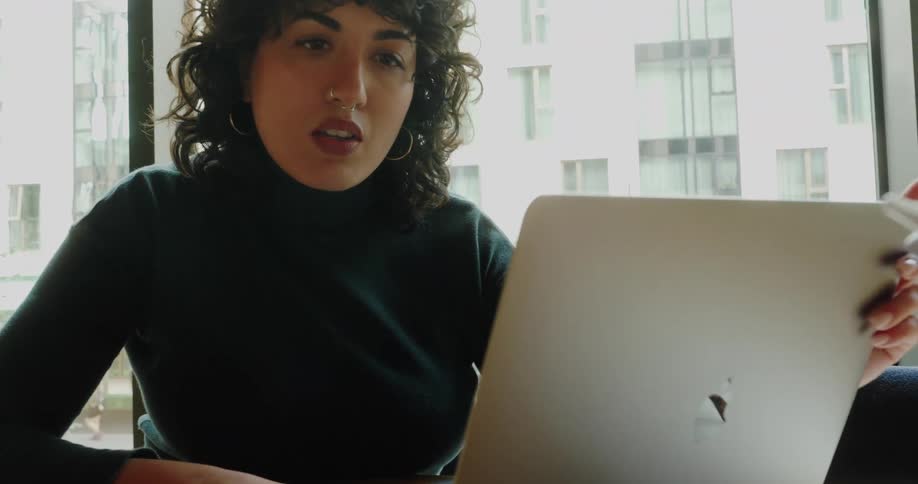 Woman sitting at an office desk working on a laptop computer