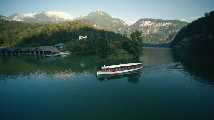 An aerial view of a boat traveling down a river