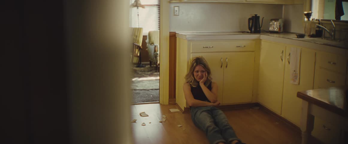 A woman sitting on the floor crying