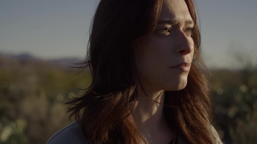 The woman opens her eyes on the field