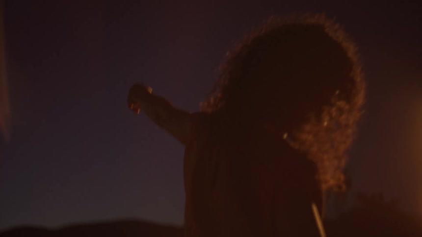 The woman is dancing at night