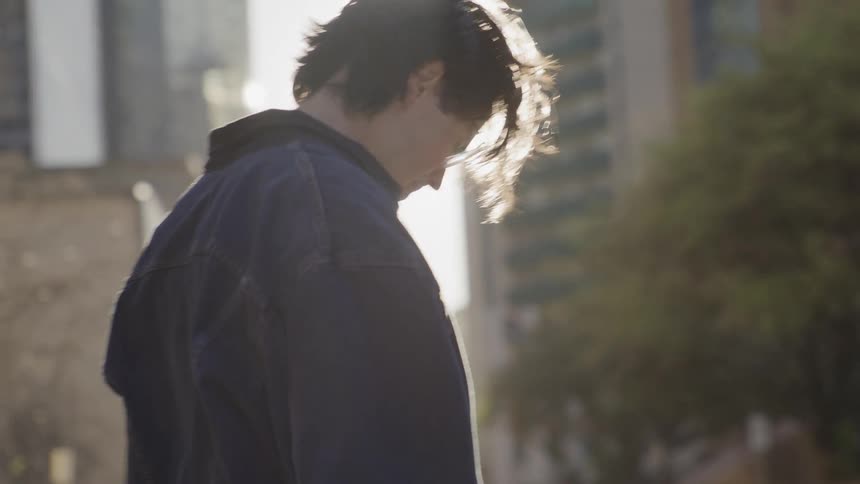 The person is walking in the city