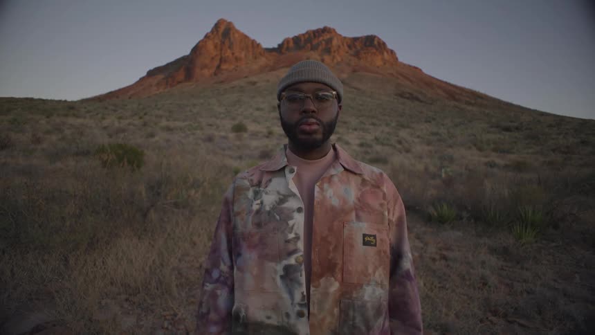 Man stands at the foot of a mountain