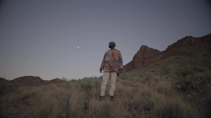 Man standing on the side of a mountain looking around