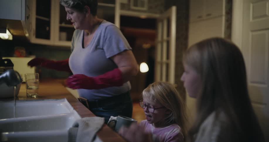 A mother giving her daughters some glasses