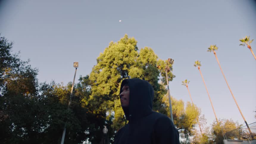 A man playing basketball outdoors