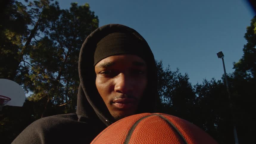 A man holding a basketball on a court