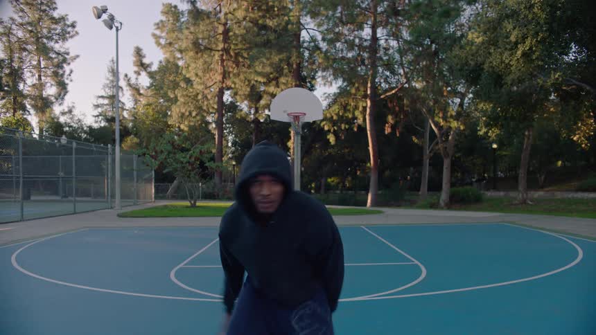 There is a prominent white baseline that curves around the court marking the perimeter of the playing area this line separates the bluepainted court surface from the surrounding gray concrete and greenery