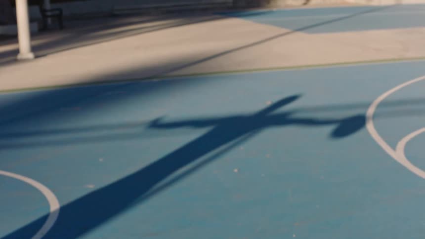 A shadow of a person with a basketball