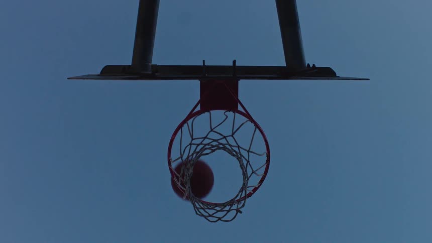 A view of a basketball going into a hoop