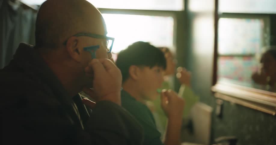 A family brushing teeth and shaving