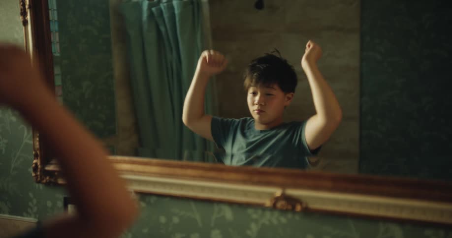 A boy standing in front of a mirror