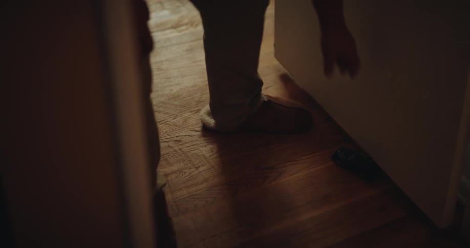Person picking up a toy car from the ground