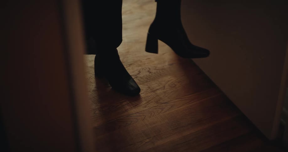 The woman walks past the doorway
