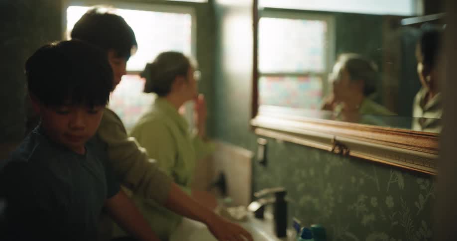 Family shares the bathroom while getting ready in the morning
