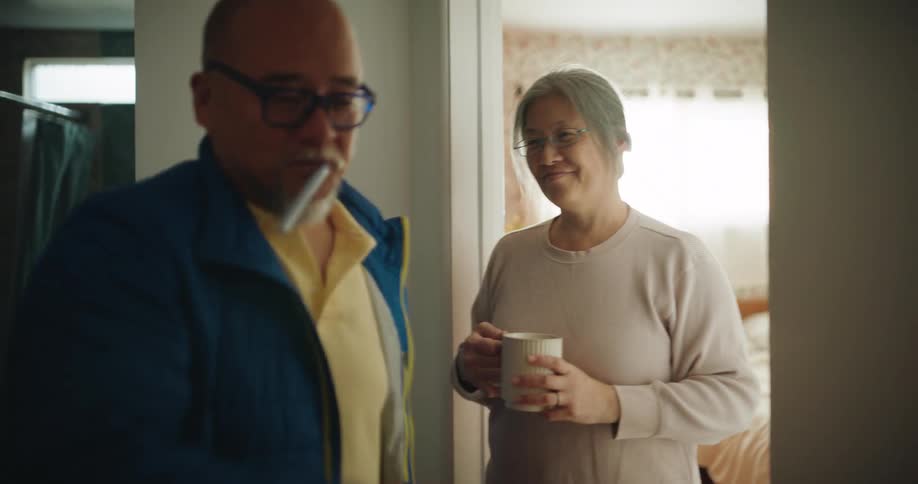 The man kisses his wife when he gets home