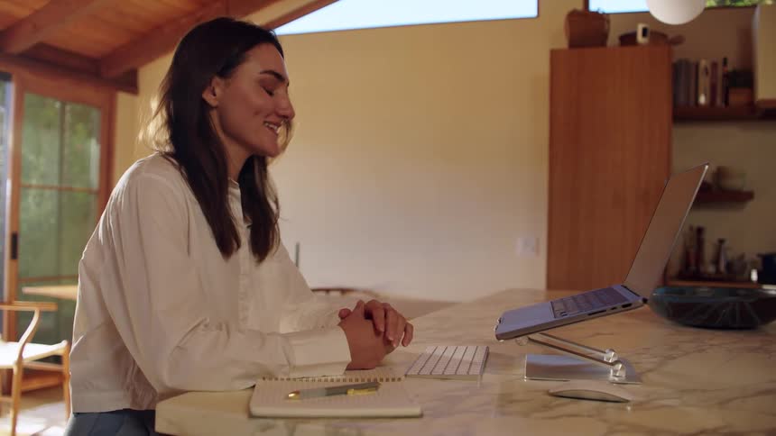 Woman working from home participates in a video call