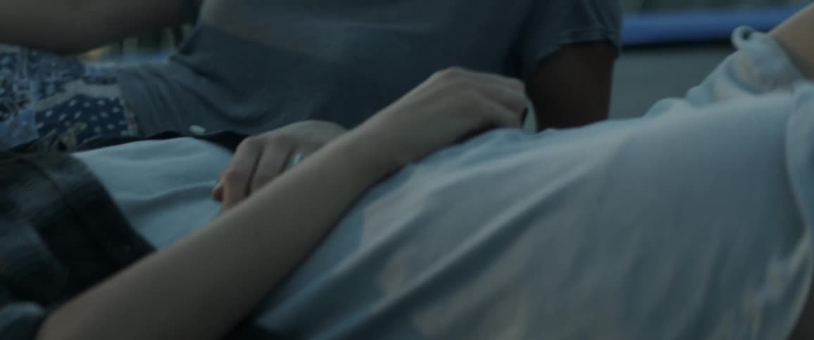 Two women lay together chatting