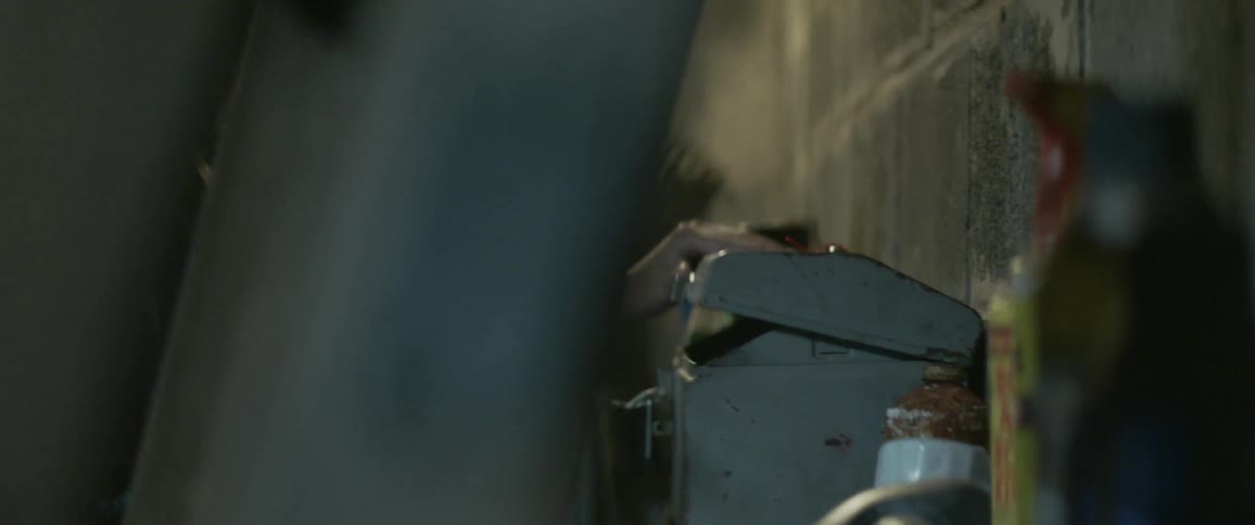 Woman takes something out of a metal box and walks away