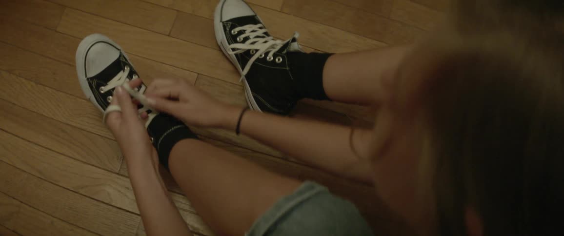 A girl puts on her shoes