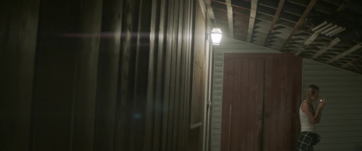 A woman walks outside with a cigarette
