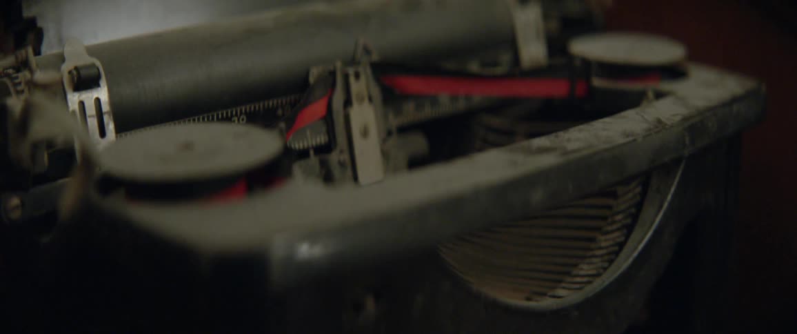 An old typewriter is covered with dust