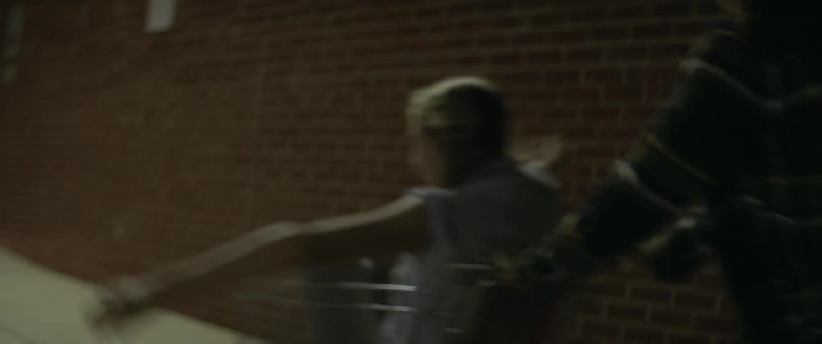 Woman pushes another woman in a shopping cart outside at night