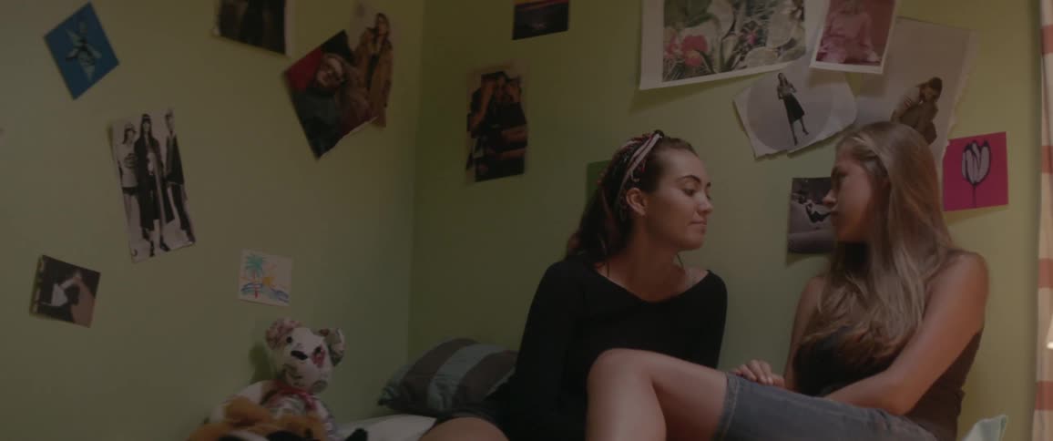 Two women sit together in bed