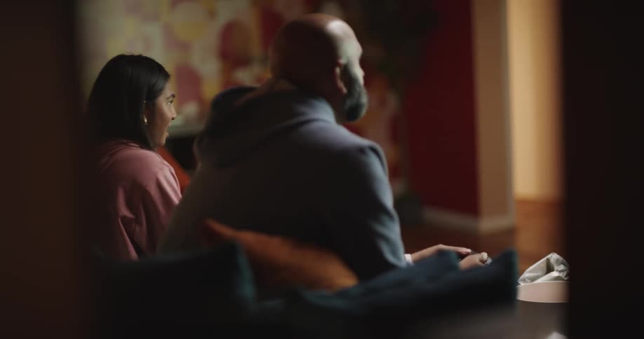 Father and daughter sitting in the living room watching