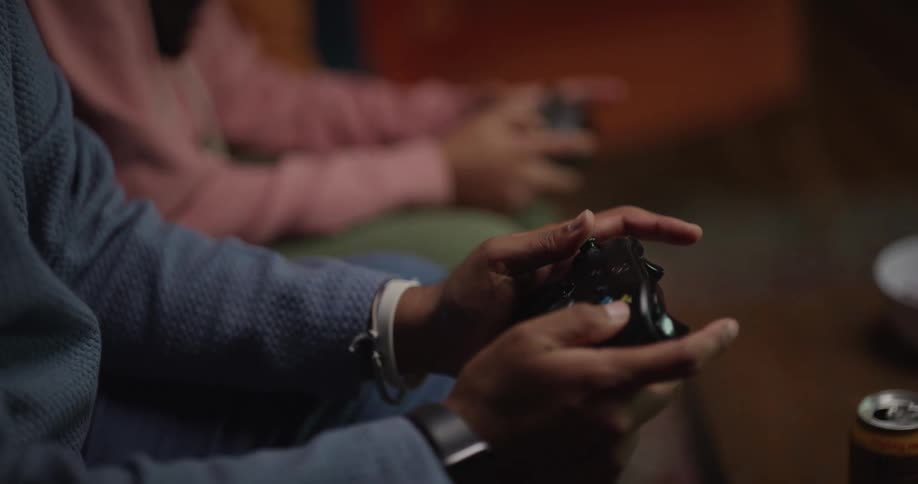 Man and his daughter play a video game in their living room