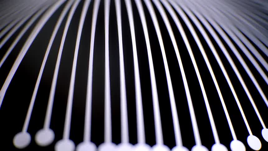 Closeup of an abstract pattern of repeating white rods emerging from a dark background