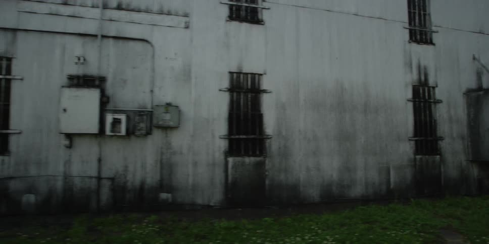 A white building is covered with filth