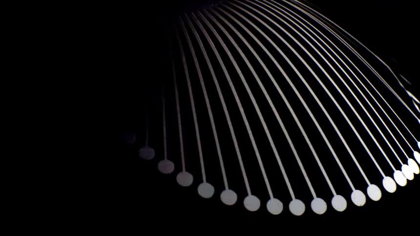 Bright lines arranged in an arc descend toward circular points creating a geometric pattern against a dark background