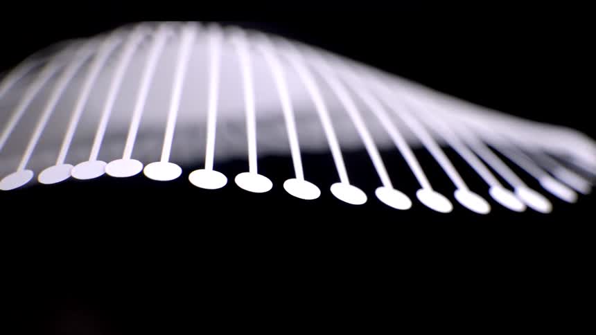 Parallel curved lines end in bright circular points against a dark background