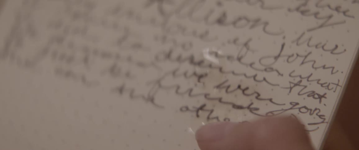 A person touches some water on the paper
