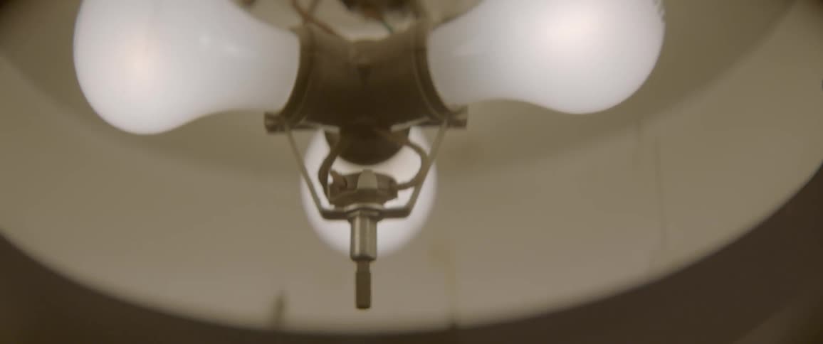 A closeup view of three light bulbs in a ceiling light fixture