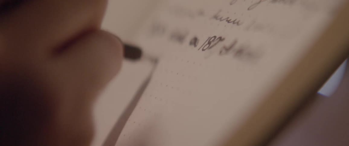 Close up of a pen writing on a piece of paper