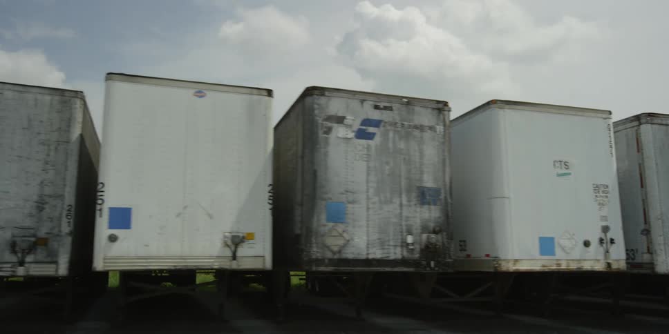 Long row of semi trailers on a cloudy day